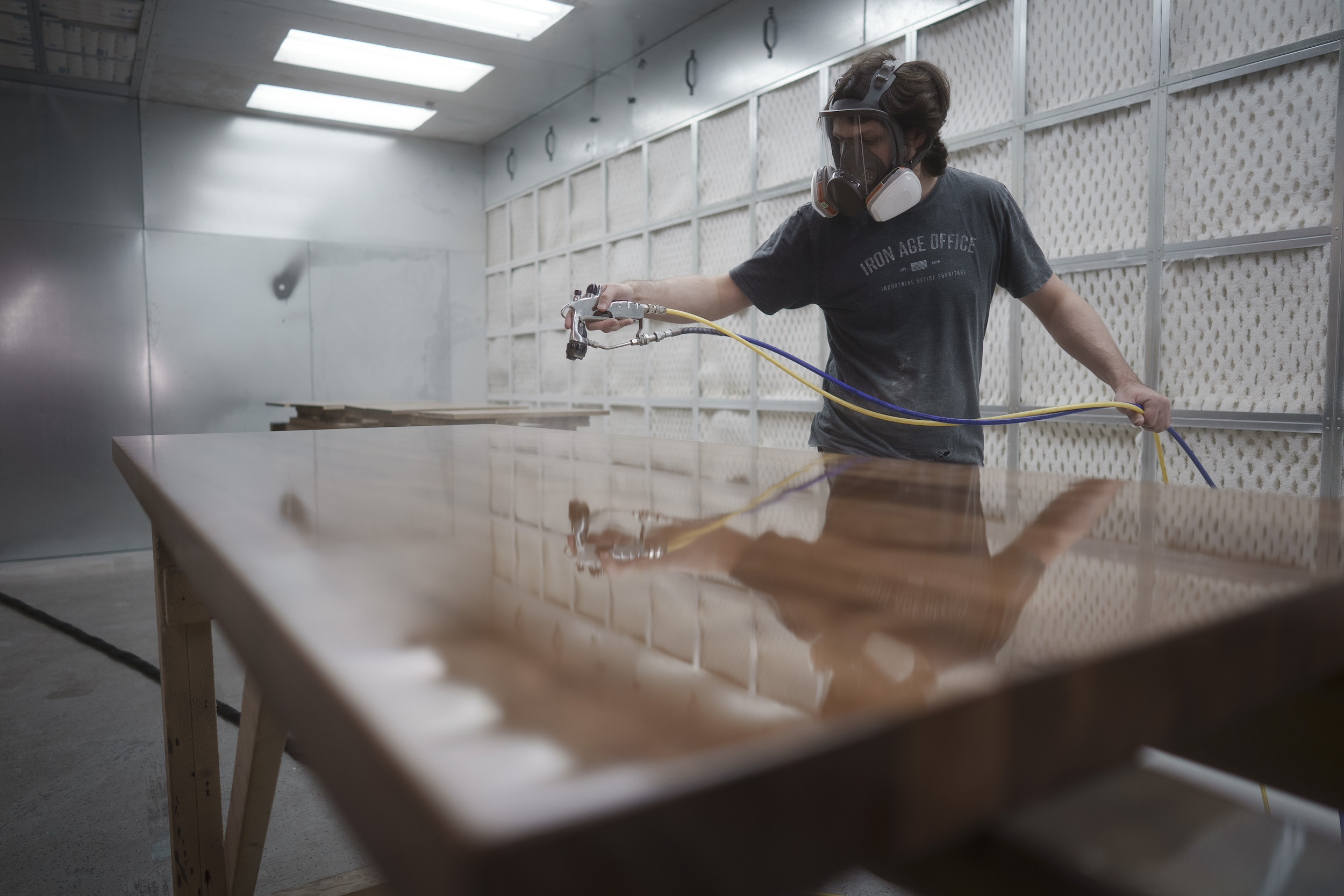 Employee spraying sealer on a table